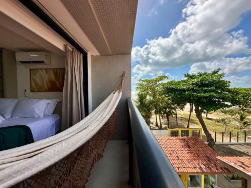 a hammock in a room with a view of a bedroom at Restinga 305- Flat vista mar no Bessa - ASKA in João Pessoa