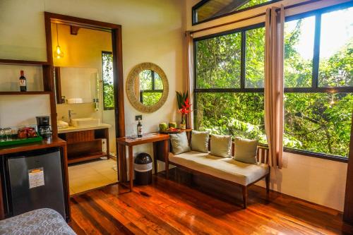 a room with a chair and a sink and a window at Maquenque Lodge in Boca Tapada