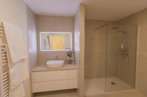 a bathroom with a sink and a shower at Coração dos Arcos in Arcos de Valdevez