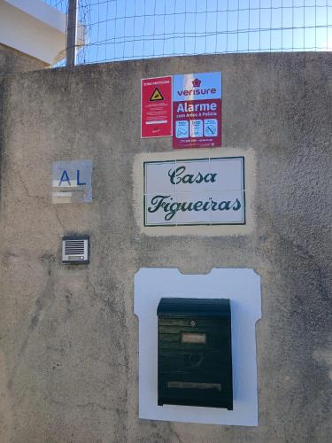 a wall with signs on the side of a building at Casa FIGUEIRAS in Bensafrim