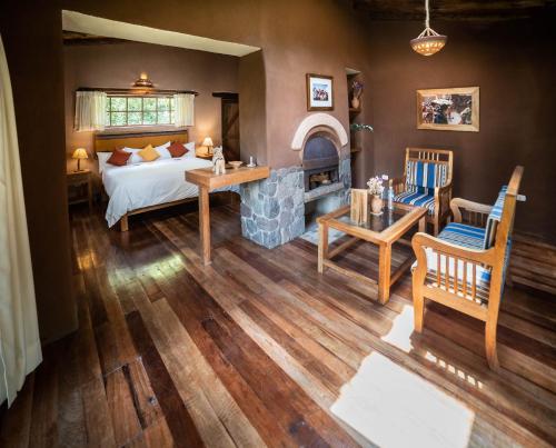 a bedroom with a bed and a fireplace at Sacred Dreams Lodge in Urubamba