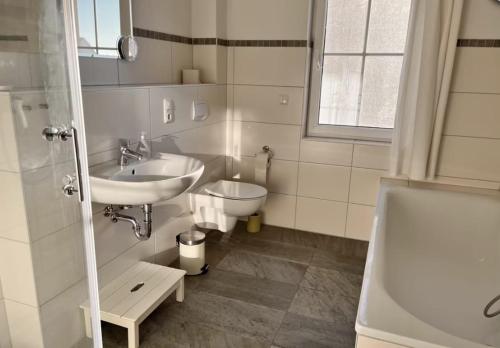 a bathroom with a sink and a toilet at Wellenläufer Breege in Breege