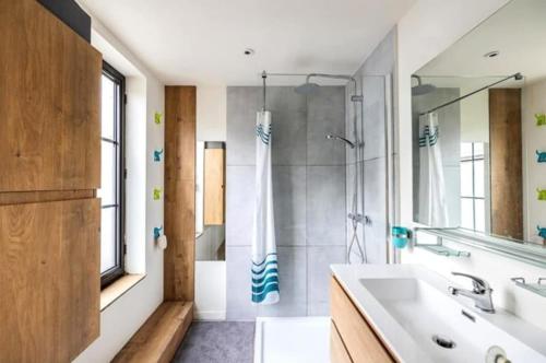a bathroom with a sink and a shower at Large bright apartment in Lessines