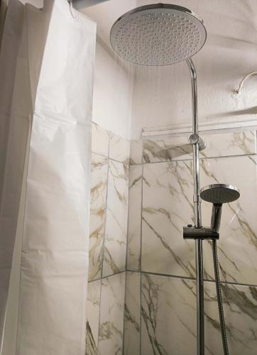 a bathroom with a shower with a shower head at Mia Nest in Artemida