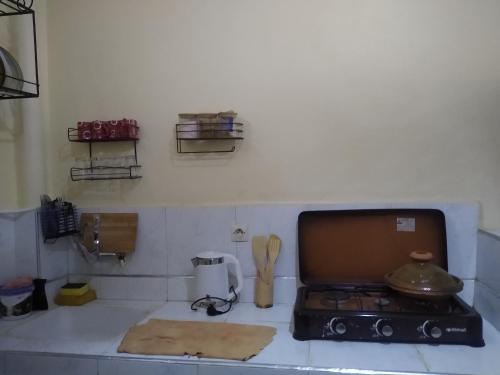a kitchen with a counter with a stove top oven at Casa di Medina - Authentic Stay with Parking in Tiznit