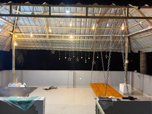 a room with chains hanging from a ceiling at Green Heavan Farm in Sadras