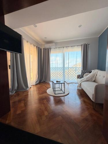 a living room with a couch and a table at Thalore room e apartments in Amantea