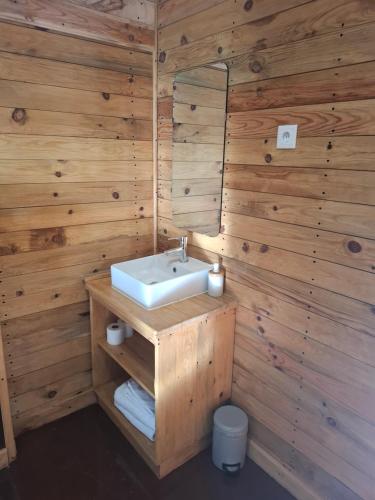 a bathroom with a sink and wooden walls at Sailor Setubal in Setúbal