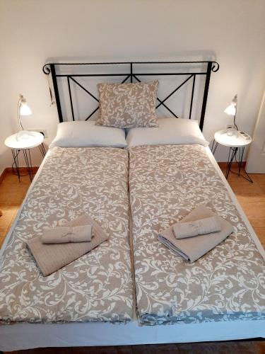 a large bed with two towels on it with two lamps at Golden Sunset Villa in Tatlisu