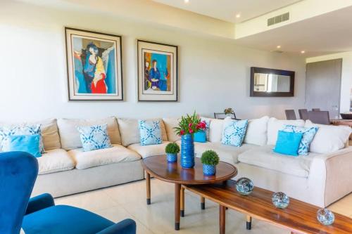 a living room with a couch and a table at 4-BR paradise view in Acapulco in Acapulco