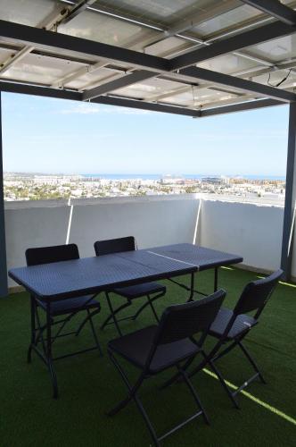 a blue table and chairs in a room with a view at The Residences Apart-Hotel By Morgan in Cabo San Lucas