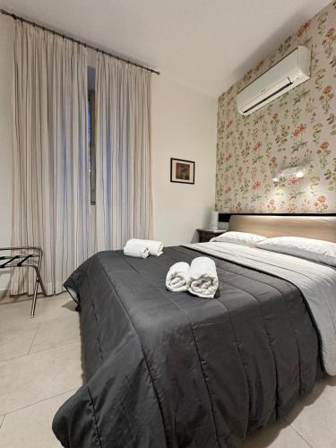 a bedroom with a large bed with towels on it at Ostello City In Hostel B&B in Catania