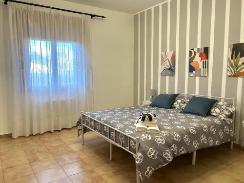 a bedroom with a bed with a dog on it at Casa Verdi in Corleone