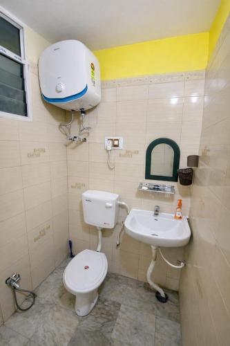 a bathroom with a toilet and a sink at mahitra beautiful homestay in Patna
