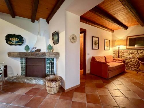 a living room with a couch and a fireplace at Casa Fochita in Gratteri