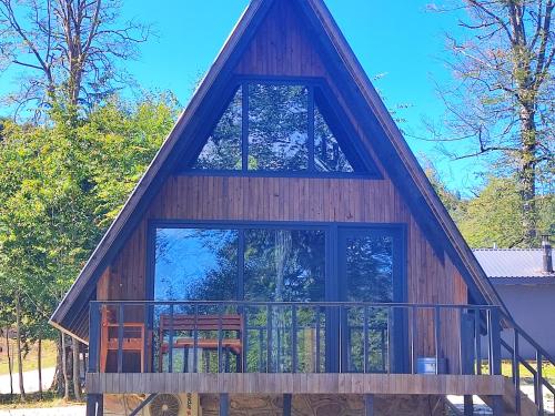 a house with a large window and a balcony at İtenicibungolow in Korgan