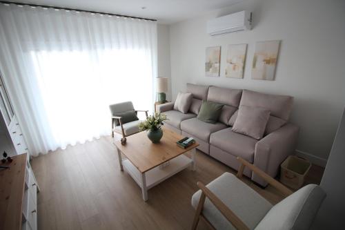 a living room with a couch and a coffee table at Atardecer en el Jerte in Cabezuela del Valle