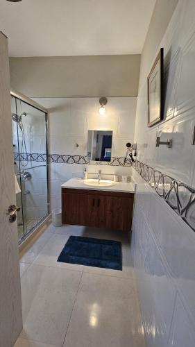 a large bathroom with a sink and a shower at The Full Maison at Ocho Rios in Ocho Rios