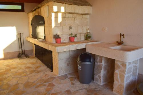 a large kitchen with a sink and a counter at Villa Marko in Ljubitovica