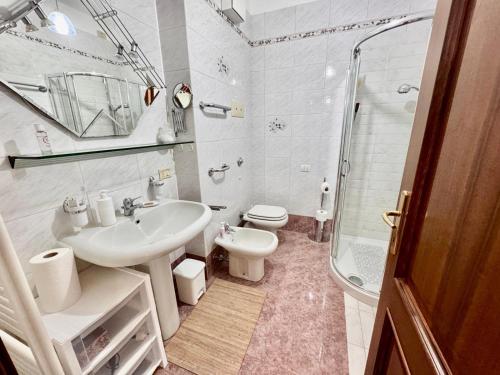 a bathroom with a sink and a toilet and a shower at Residence agli Oleandri in Manerba del Garda