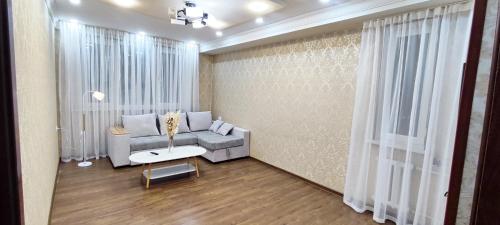 a living room with a couch and a table at Old Town Apartment in Tashkent