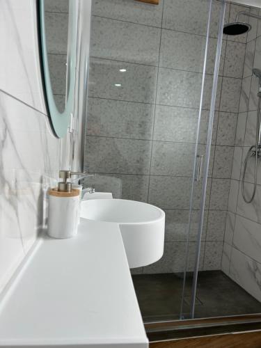 a bathroom with a sink and a shower at Central House in Ribeira Grande