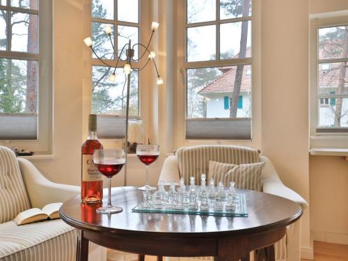 a table with wine glasses and a bottle of wine at Landhaus Victoria in Boltenhagen