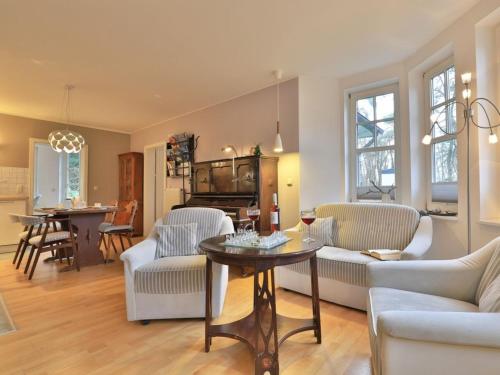 a living room with a table and chairs at Landhaus Victoria in Boltenhagen