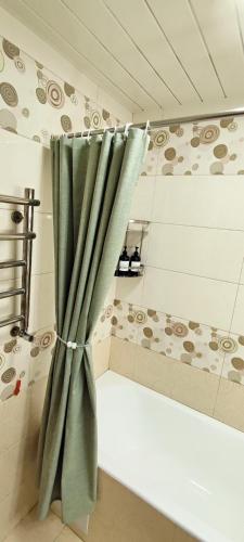 a shower curtain in a room with a tub at Old Town Apartment in Tashkent