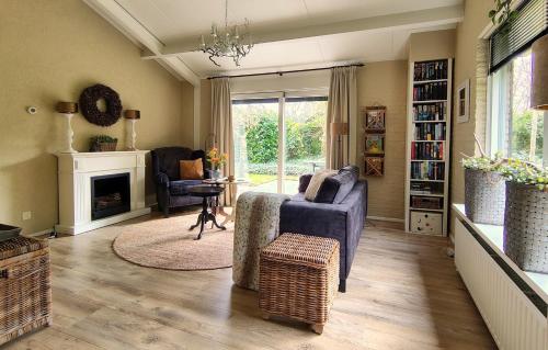 a living room with a couch and a fireplace at Hof van Benten in Ermelo