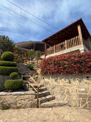 a set of stone stairs leading to a building at Casa do Penedo in Viana do Castelo
