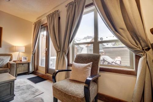 a living room with a chair and a window at Fire Mountain 204 2 Level, 2 bed, great views! in Canmore
