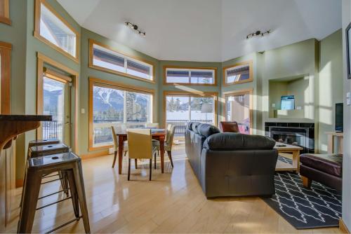 a living room with a couch and a table at 212 Alpine Village Spacious 2Bed-2Bath-Mtn Views! in Canmore