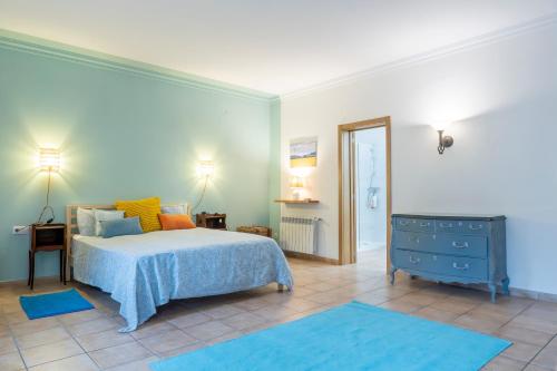 a bedroom with a blue bed and a blue dresser at Casa con jardìn en Son Españolet in Palma de Mallorca