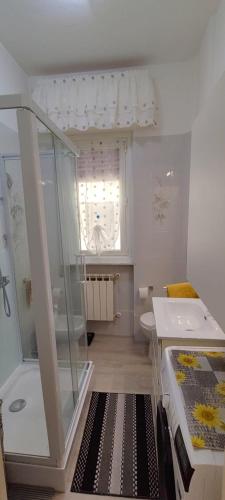 a small bathroom with a shower and a sink at Casa Martina in Cogoleto