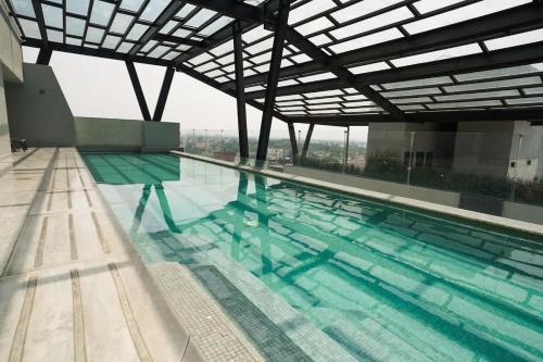 a swimming pool with a view of a building at Luxury 3BR Pool and Gym in Roma in Mexico City