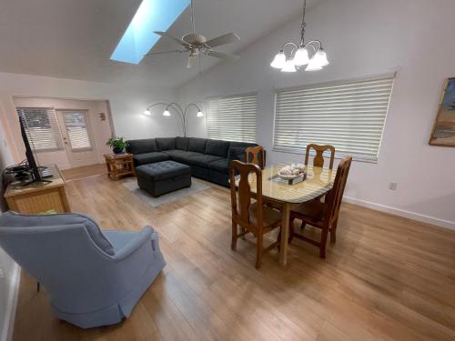 a living room with a couch and a table and chairs at Stylish budget friendly retreat! in Lake Placid