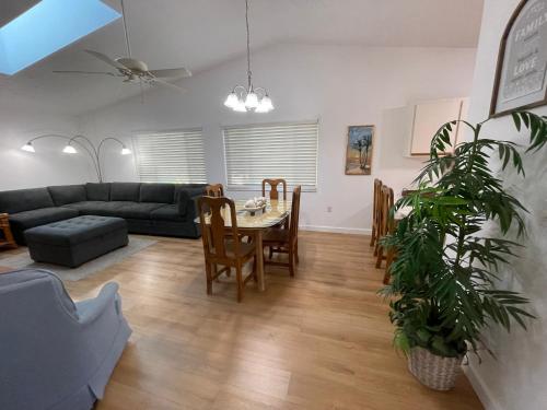 a living room with a table and a couch at Stylish budget friendly retreat! in Lake Placid