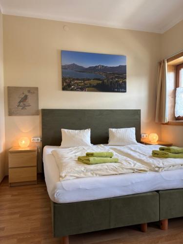 a bedroom with a large bed with two pillows on it at Pension Göschlberger in Mondsee