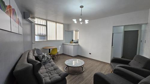 a living room with two couches and a table at Comodidades, modernidad, céntrico in Caracas