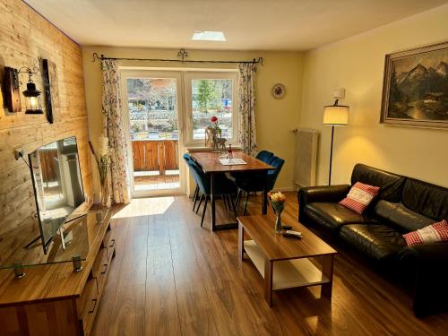 a living room with a couch and a table at Alpenlodge Ferienwohnung 5 in Thiersee