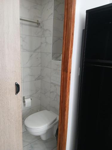 a bathroom with a white toilet in a room at hôtel des reformés in Marseille
