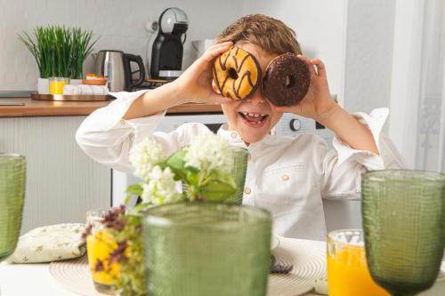 a person sitting at a table with a doughnut on his face at Sado River Haven in Setúbal