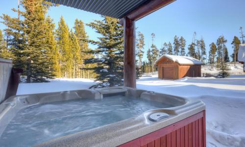 a hot tub in the snow with a gazebo at Powder Ridge Cabin - 9A Red Cloud in Big Sky