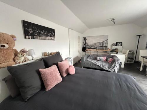 a bedroom with a bed with a teddy bear on it at La Vie est Belle chambre d hôte in Verviers