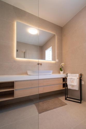 a bathroom with a sink and a mirror at NEW! Villa Rabella - Luxury Oasis, Island Rab in Rab