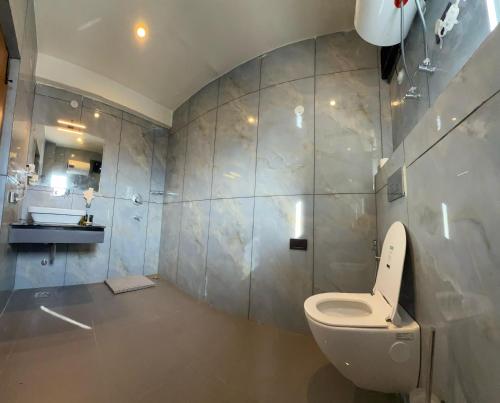 a bathroom with a toilet and a sink at Cho Suites in Leh