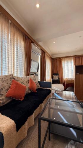 a living room with a couch and a glass table at Cho Suites in Leh