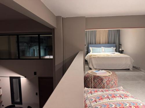 a large bedroom with a bed and a stool in it at The 9 loft in Pyrgos