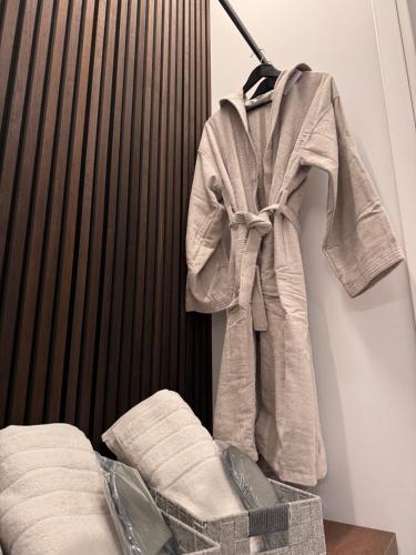 a robe hanging on a wall next to a bed at The 9 loft in Pyrgos